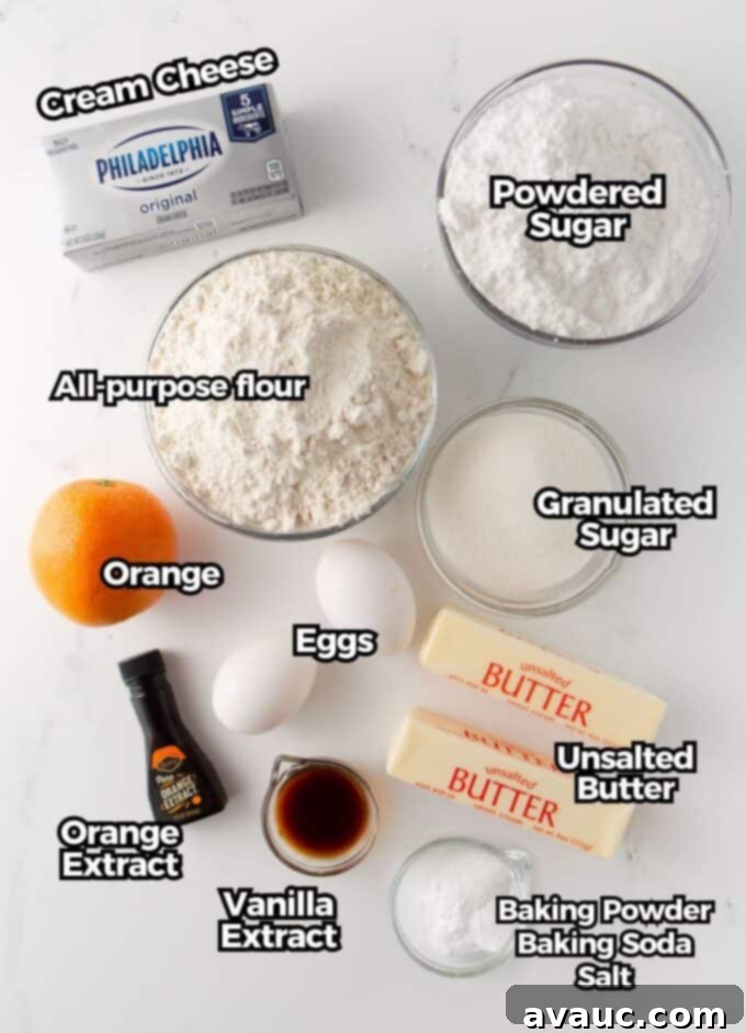 Glazed Orange Sugar Cookies 4 Assorted ingredients for frosted orange sugar cookies laid out on a table, including flour, sugars, butter, eggs, orange extract, and fresh oranges.