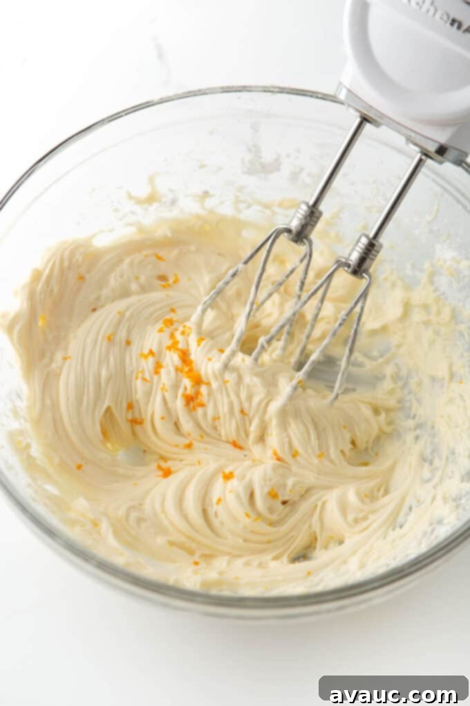 Glazed Orange Sugar Cookies 9 bowl of freshly made orange cream cheese frosting, ready for piping or spreading