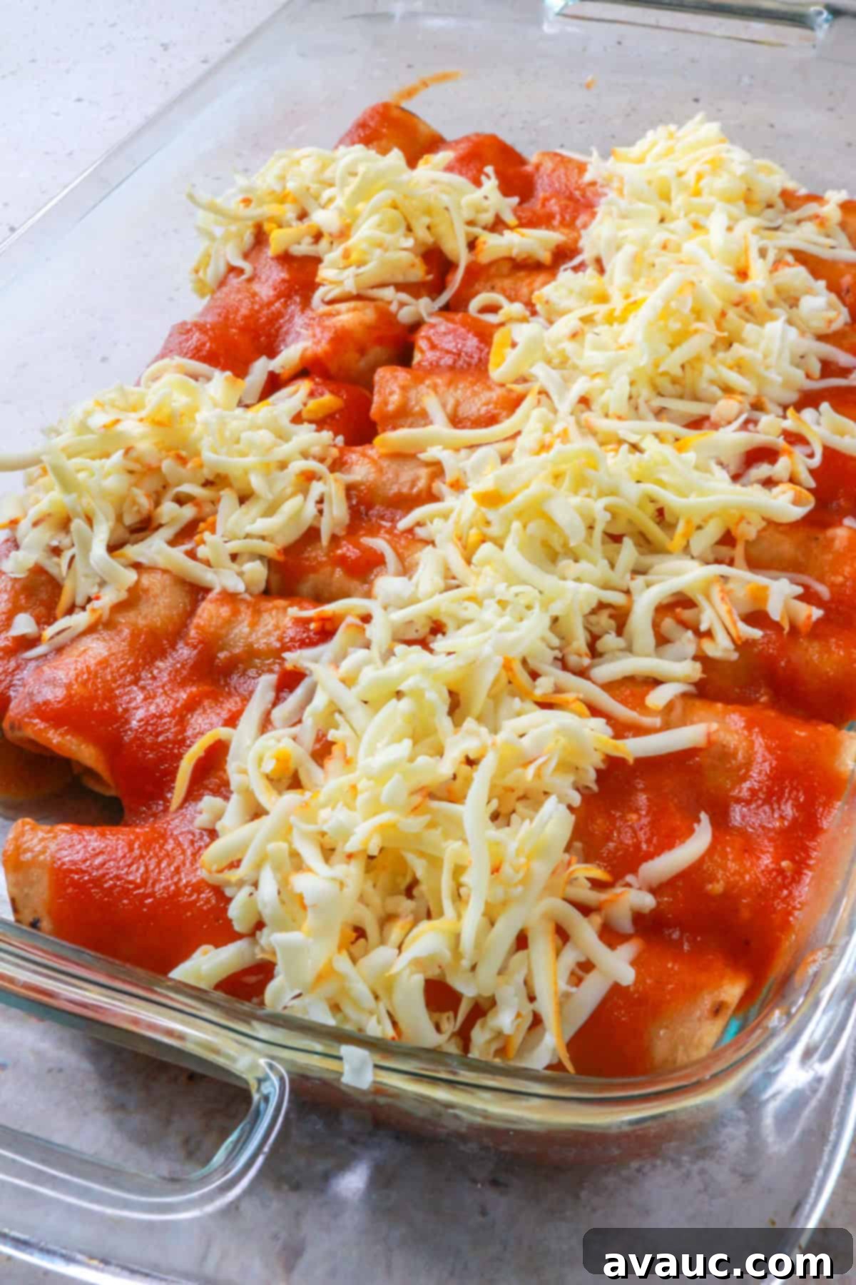 Baking dish with entomatadas topped with shredded cheese