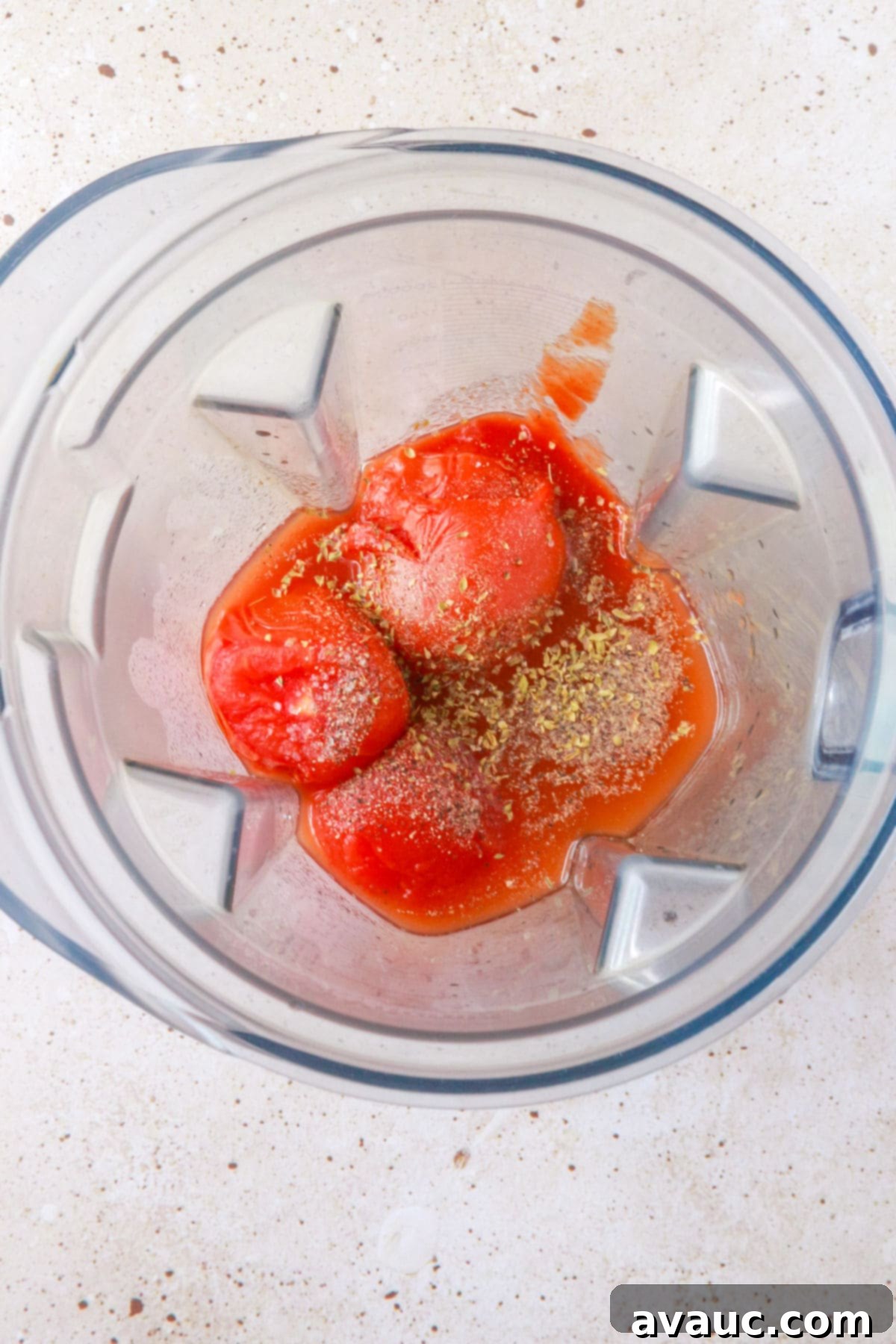 Whole tomatoes and spices in a blender
