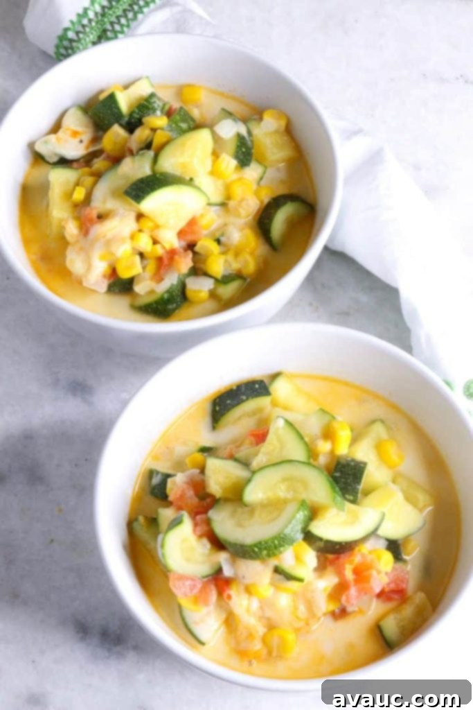 Cheesy Calabacitas 2 Two steaming white bowls filled with creamy Calabacitas con Queso, garnished and ready to be enjoyed