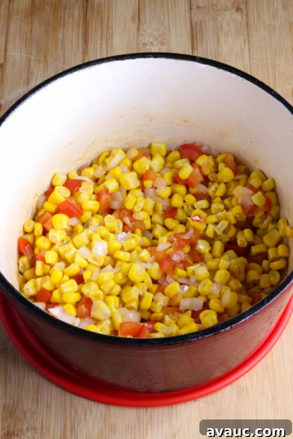 Cheesy Calabacitas 6 Sautéed corn, onion, garlic, and tomato creating a fragrant base in a red pot for the creamy Calabacitas con Queso