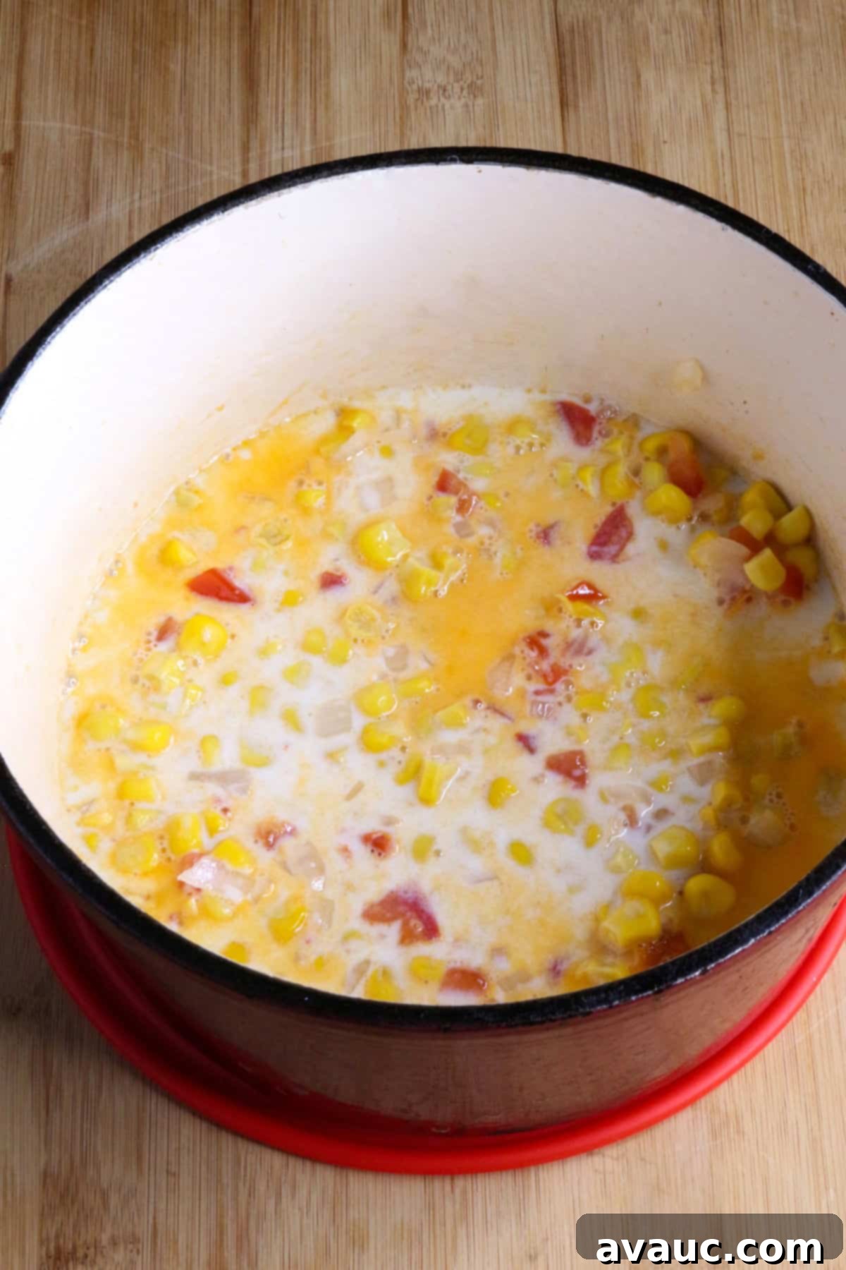 Cheesy Calabacitas 7 Milk being added to the pot of vegetables, creating the creamy base for the Calabacitas con Queso