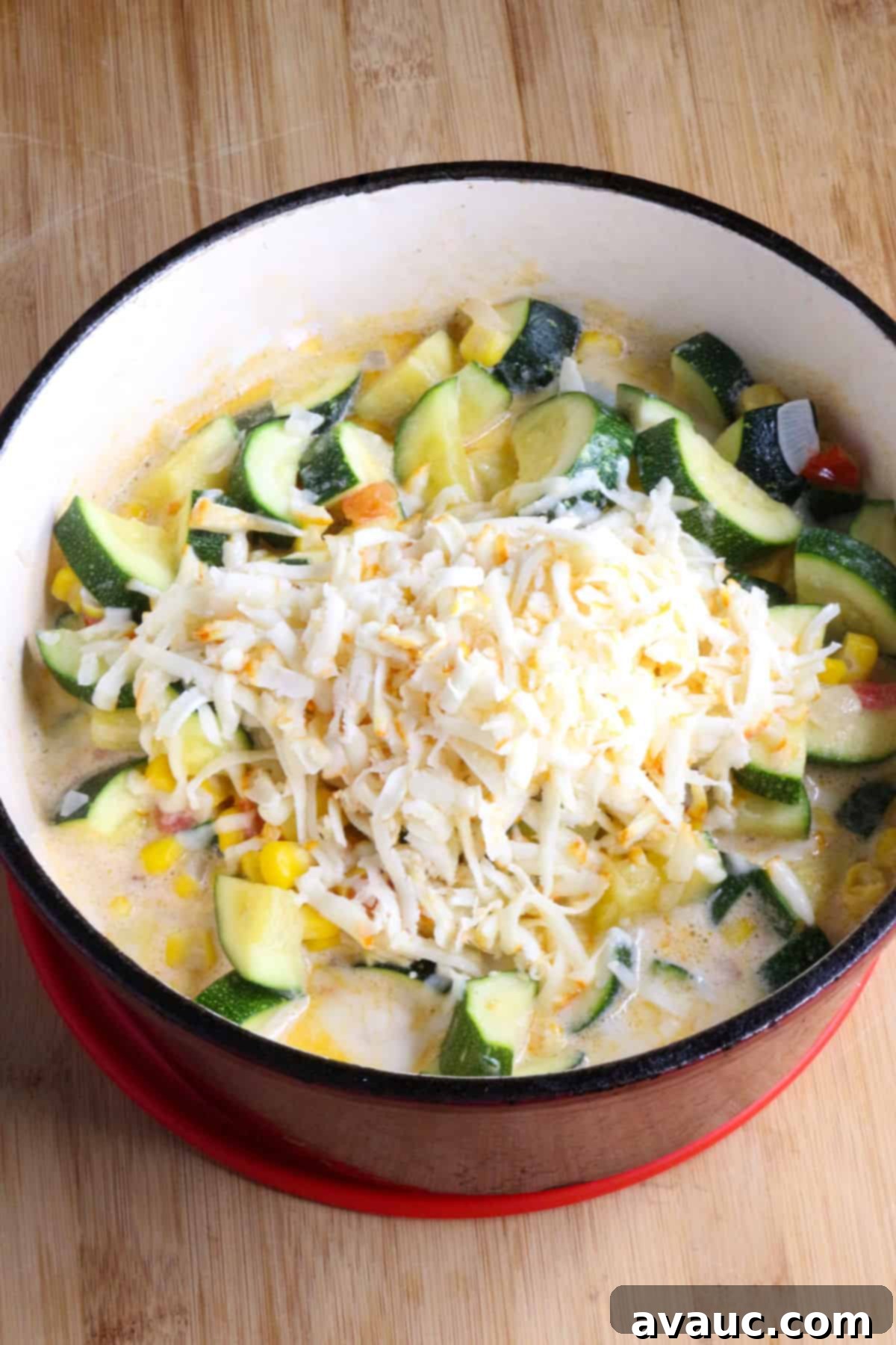 Cheesy Calabacitas 9 A finished pot of creamy Calabacitas con Queso, rich with melted shredded white cheese, ready to be served