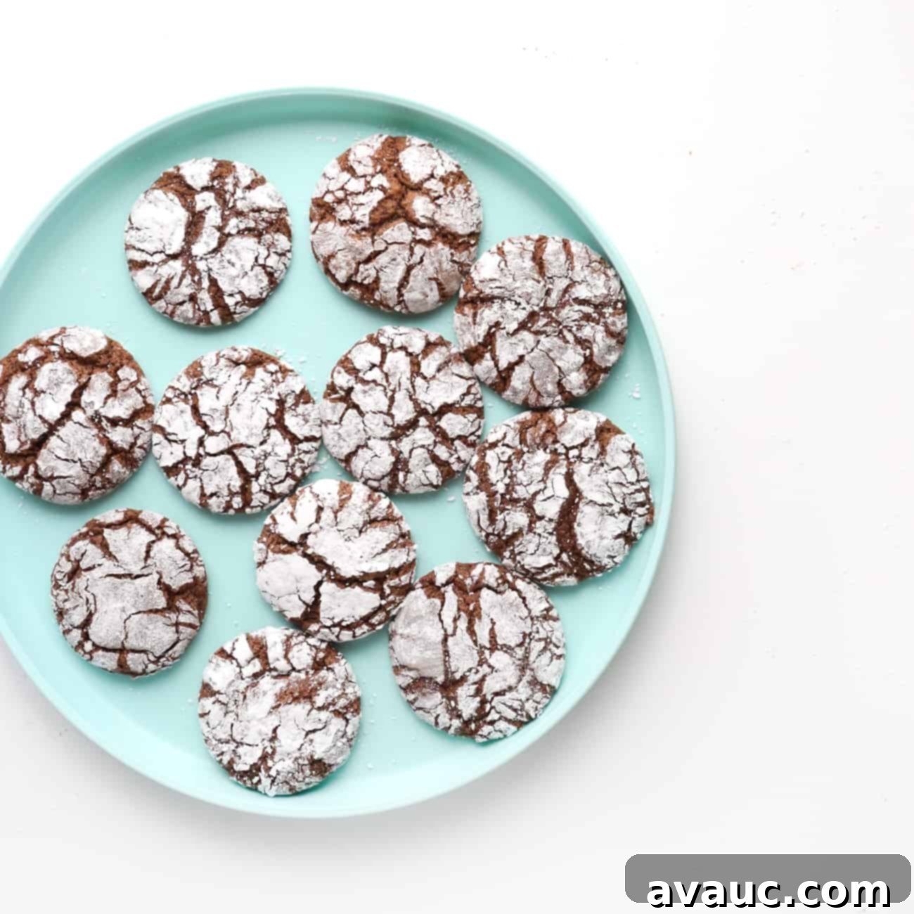 Blue plate filled with perfectly baked crackle-top chocolate brownie cookies, ready to be enjoyed.