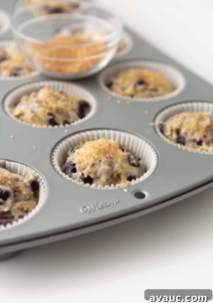 pan of sour cream blueberry muffins with turbinado sugar