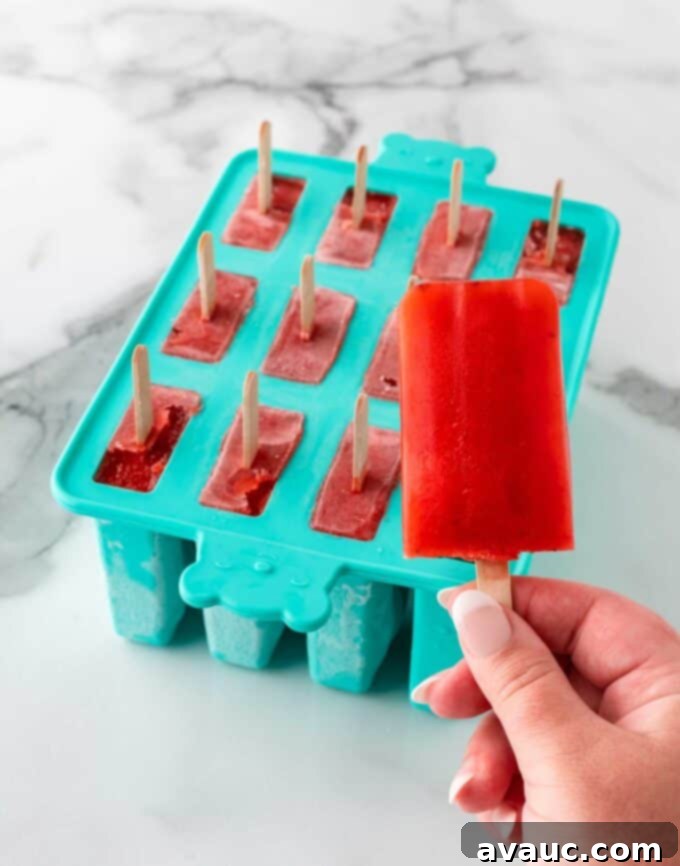 Easy Strawberry Lemonade 8 Strawberry lemonade popsicles in a popsicle mold, ready for freezing.