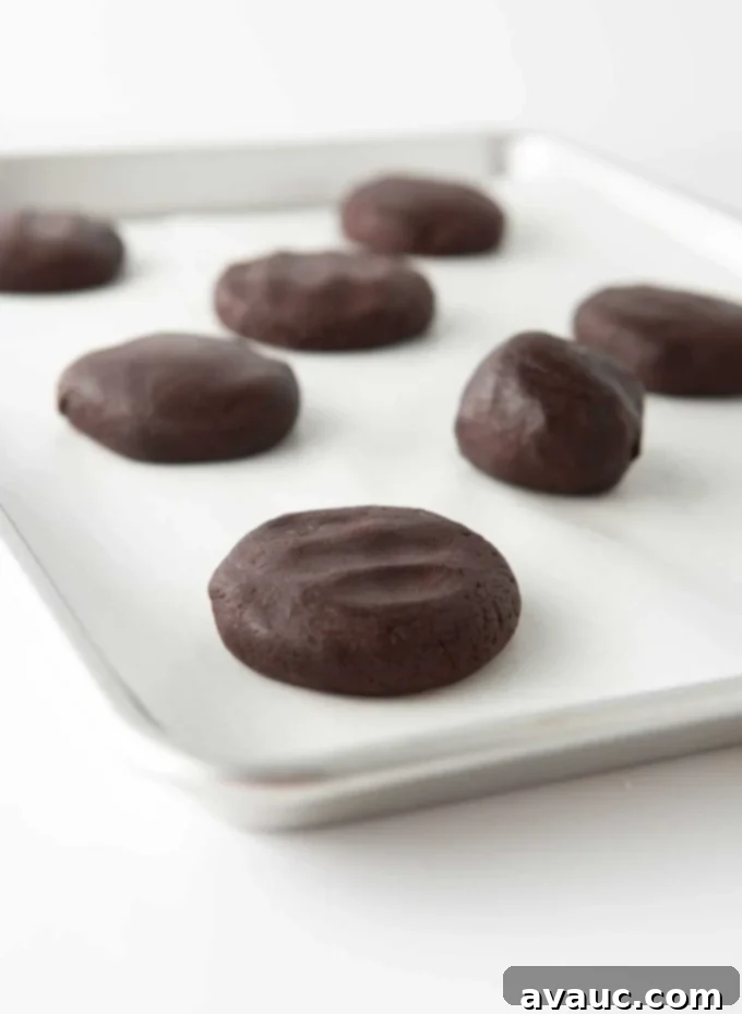 andes mint cookie dough balls slightly flattened on cookie tray