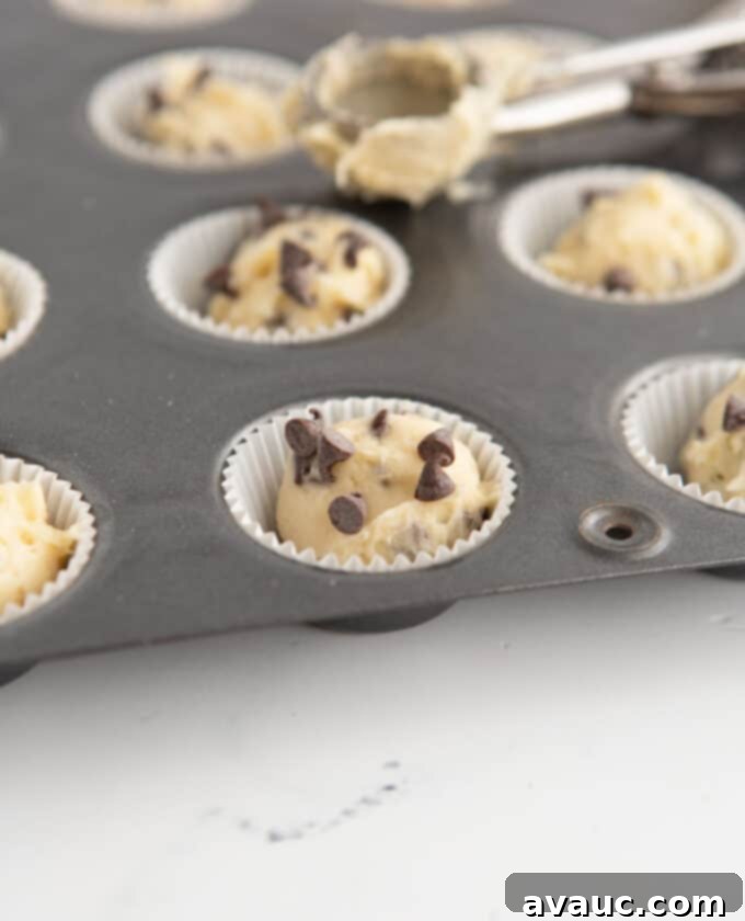 Mini Chocolate Chip Muffins 7 mini chocolate chip muffins in paper liner and pan ready for oven