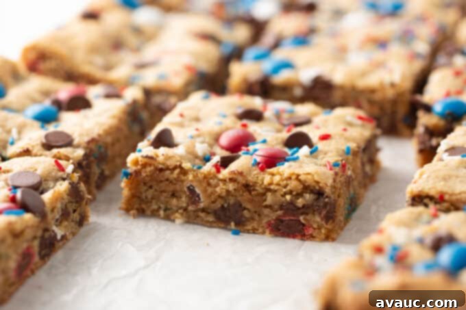 close up of a single square of 4th of july monster cookie bar showing the soft interior and colorful candies