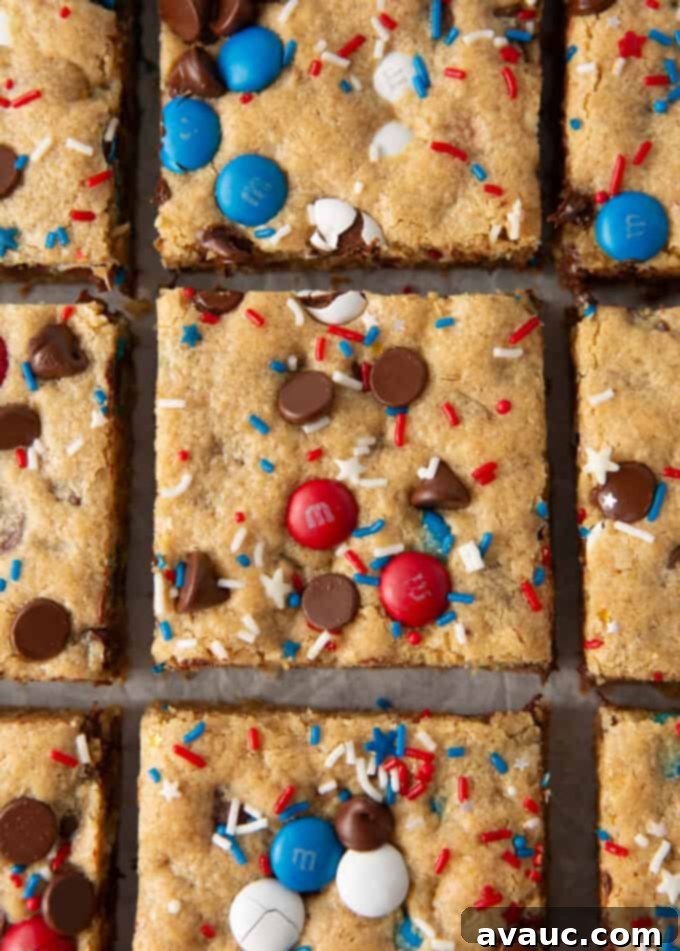 neatly cut squares of 4th of july monster cookie bars arranged on a white serving platter