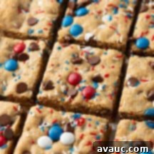 squares of 4th of july monster cookie bars arranged on a cooling rack, showcasing the mix-ins