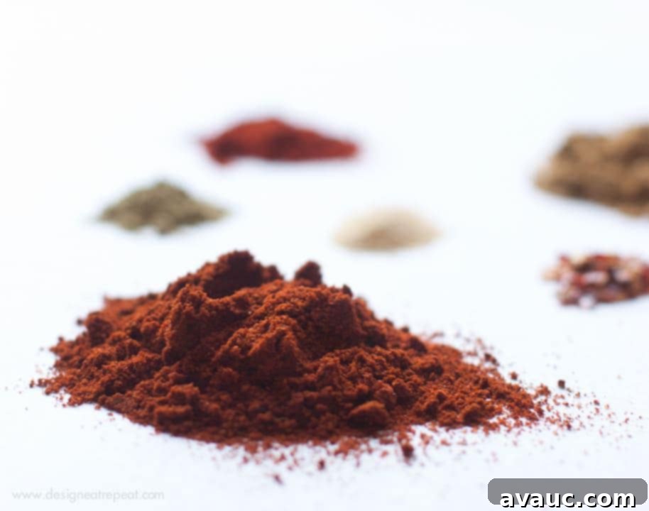 A close-up of a bowl filled with homemade taco seasoning spices