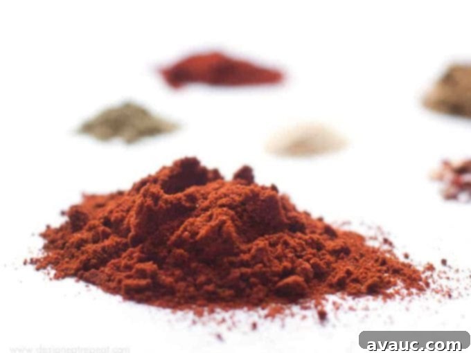 A selection of spices used in homemade taco seasoning, highlighting chili powder and cumin