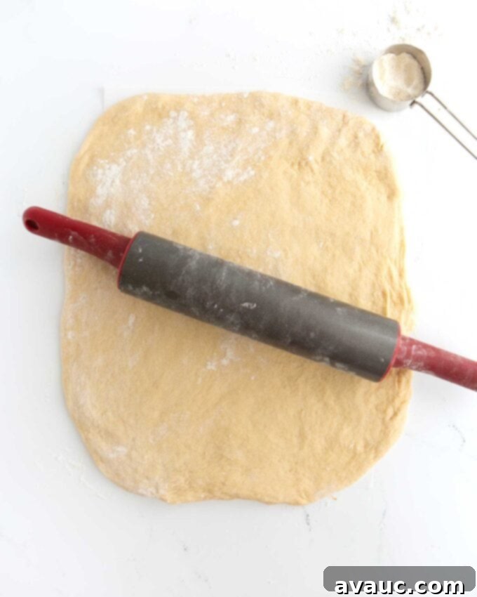 Effortless Cinnamon Swirl Knots 8 rolled out dough with rolling pin