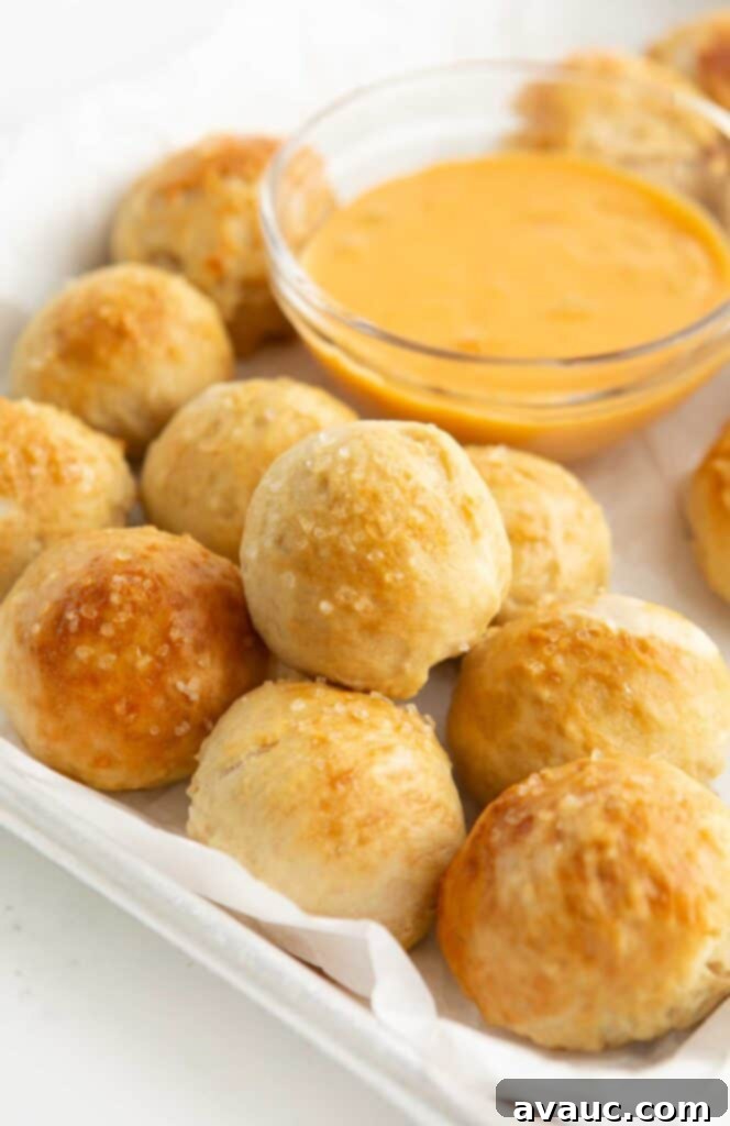 Effortless Soft Pretzel Bites 2 tray of soft pretzel bites with bowl of cheese