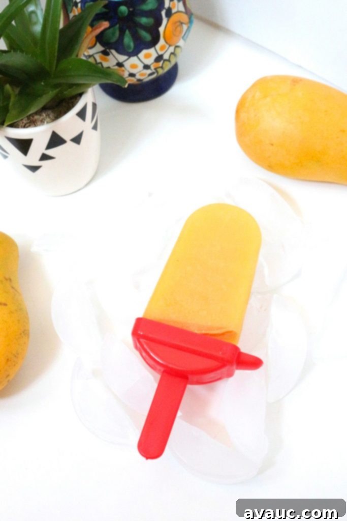 Tropical Mango-Pineapple Paletas, a delicious fruit-packed treat for the warm weather.