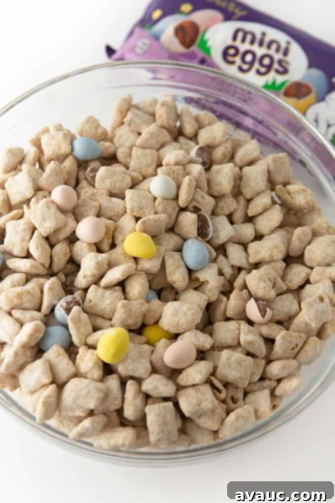 Close up of white chocolate peanut butter puppy chow with Cadbury mini eggs in a white bowl