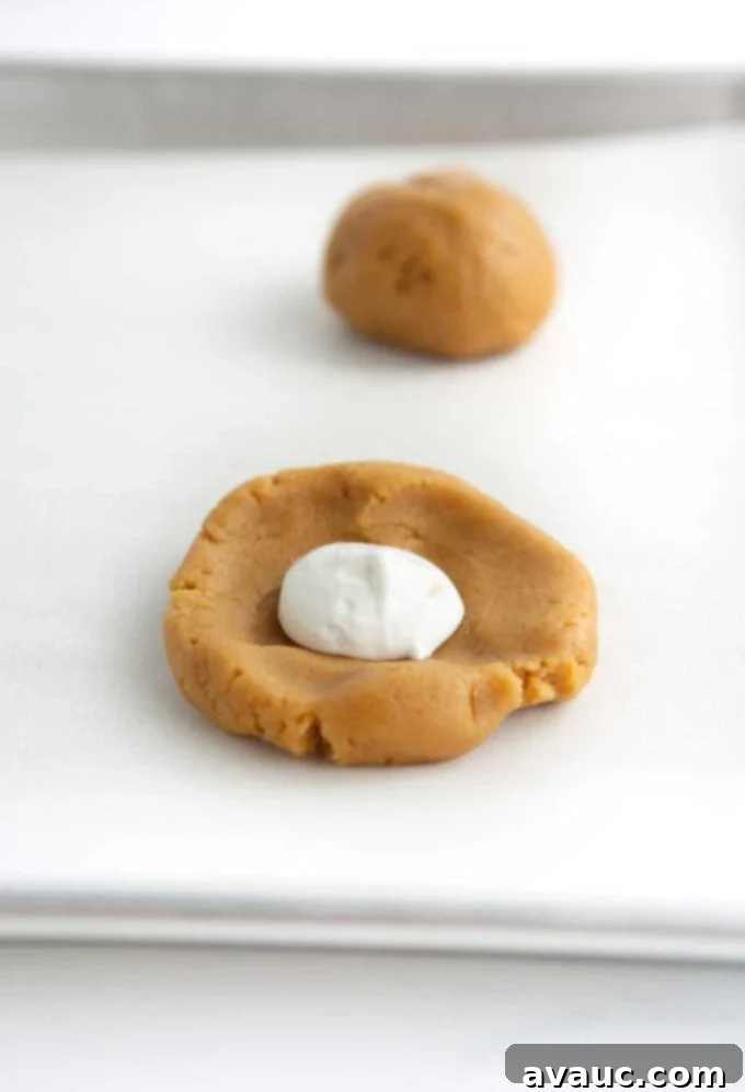 marshmallow creme in the center of peanut butter cookie dough