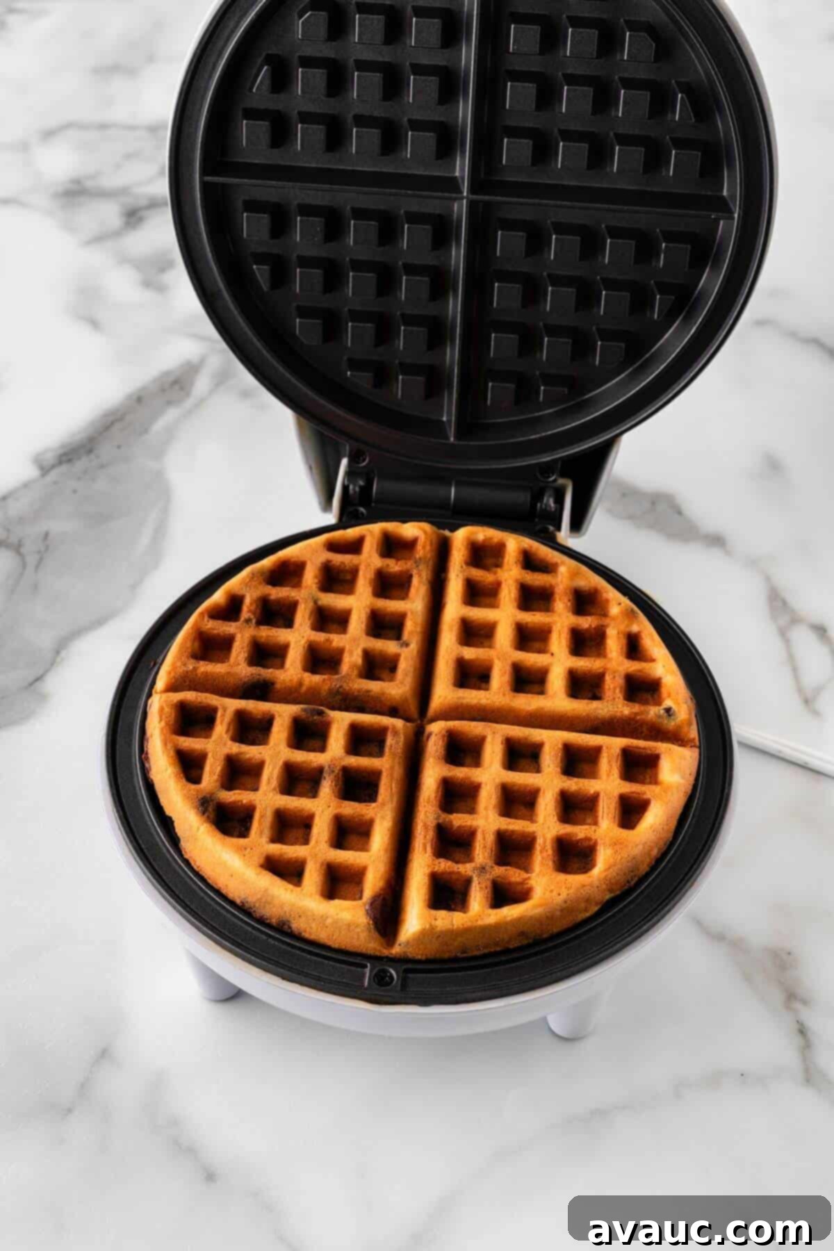 Sweet Morning Chocolate Chip Waffles 15 Cooked chocolate chip waffle removed from waffle iron, showcasing its golden-brown color.