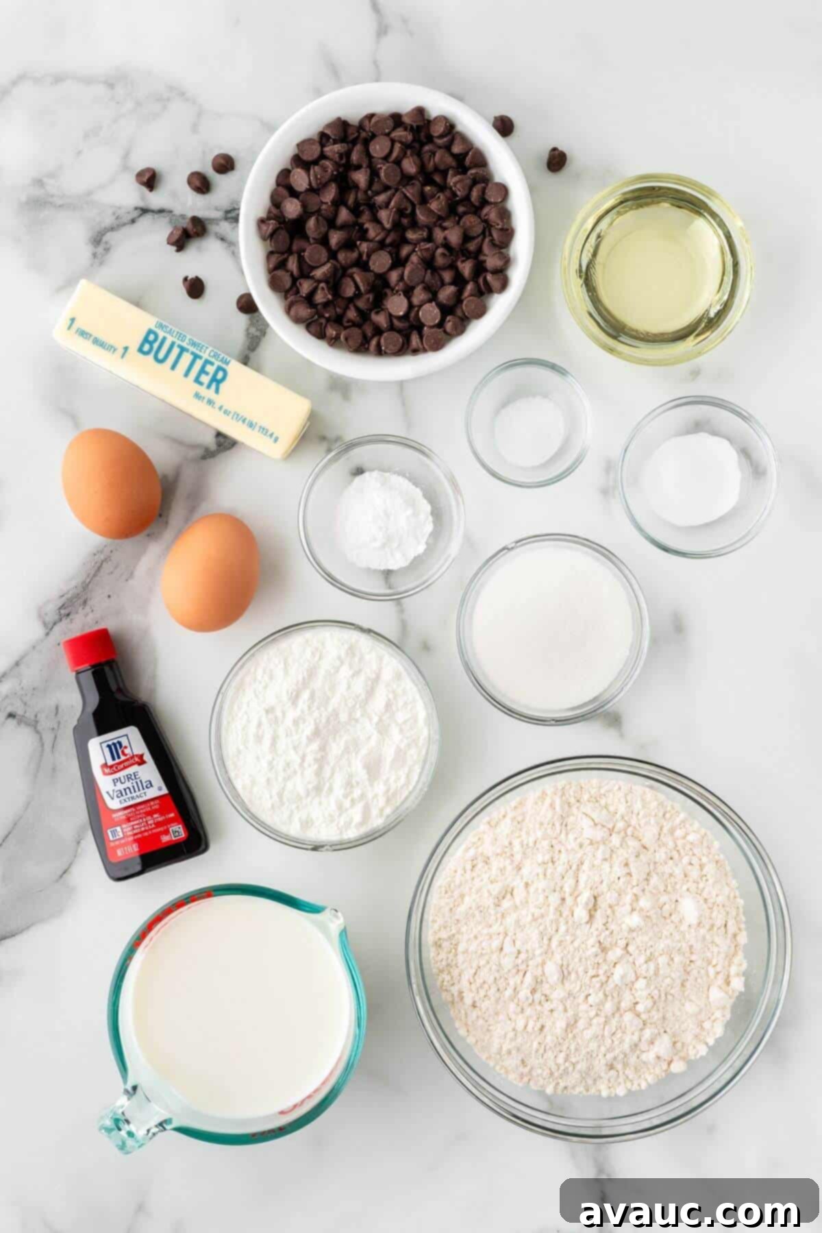 Sweet Morning Chocolate Chip Waffles 4 A selection of ingredients for chocolate chip waffles laid out on a table, including flour, sugar, butter, and chocolate chips.