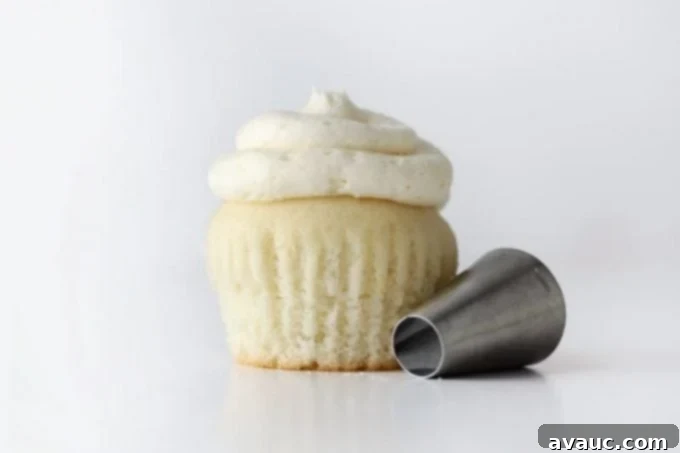 White wedding cupcake with piping tip.