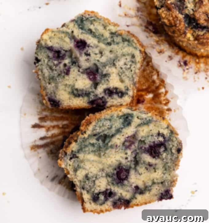 Close-up of the inside texture of a jumbo blueberry muffin, showing moist crumb and visible blueberries.