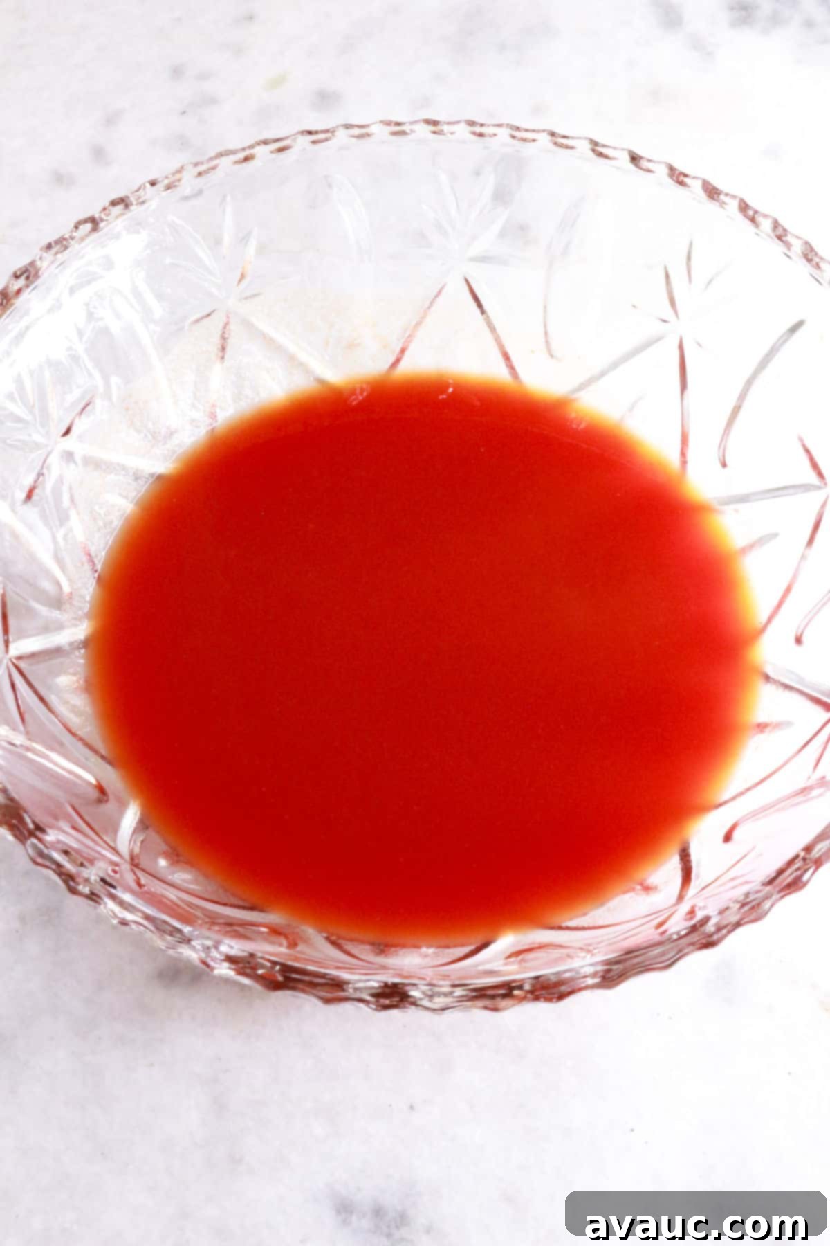 Vibrant Mexican Shrimp Cocktail 4 Glass bowl with tomato juice, a foundational element for the shrimp cocktail base.