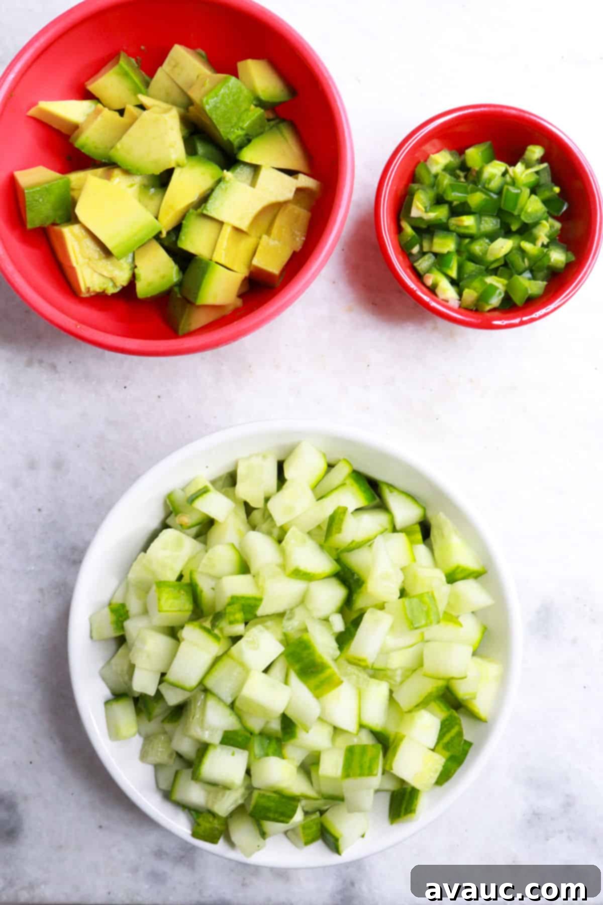 Vibrant Mexican Shrimp Cocktail 8 Bowls of diced avocado, diced jalapeños, and diced cucumber, perfect garnishes for Mexican shrimp cocktail.