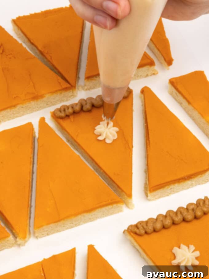 piping white whipped cream dollop on pumpkin pie slice sugar cookie bar