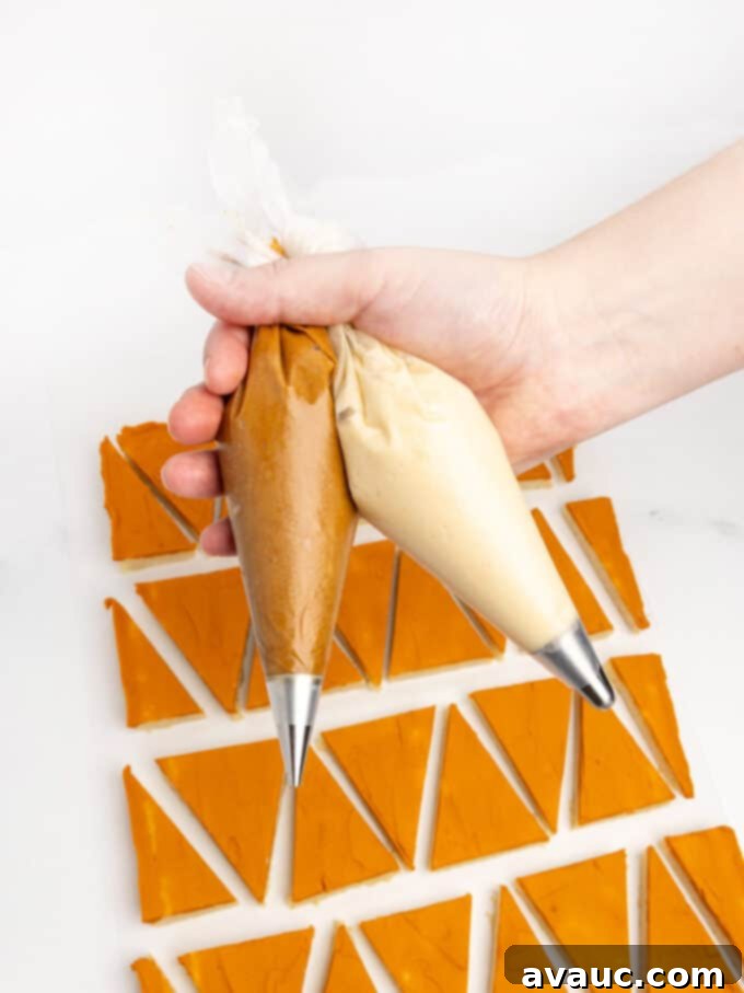 hand holding piping bags with brown frosting and white frosting