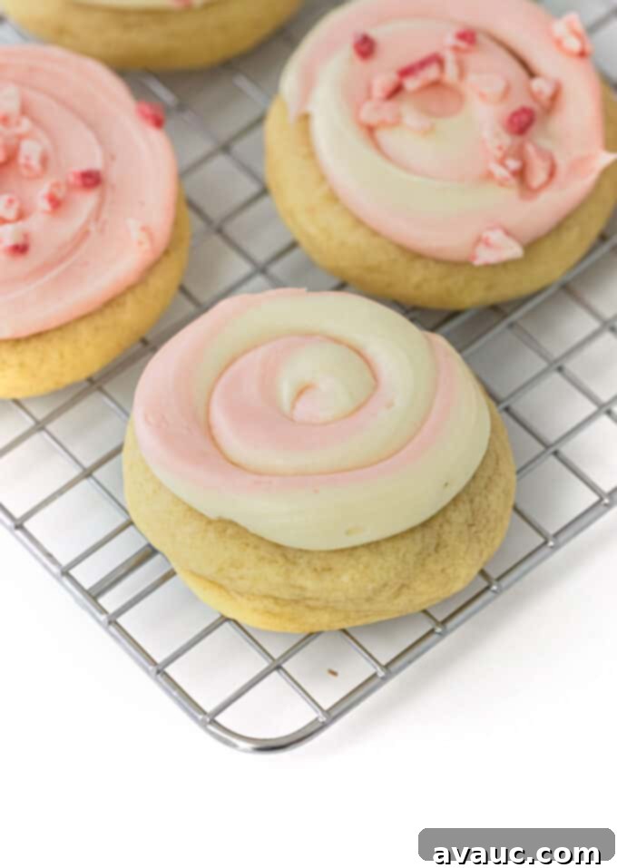 Festive Frosted Peppermint Sugar Cookies 13 A frosted peppermint sugar cookie adorned with a pink and red swirl, showcasing festive elegance.