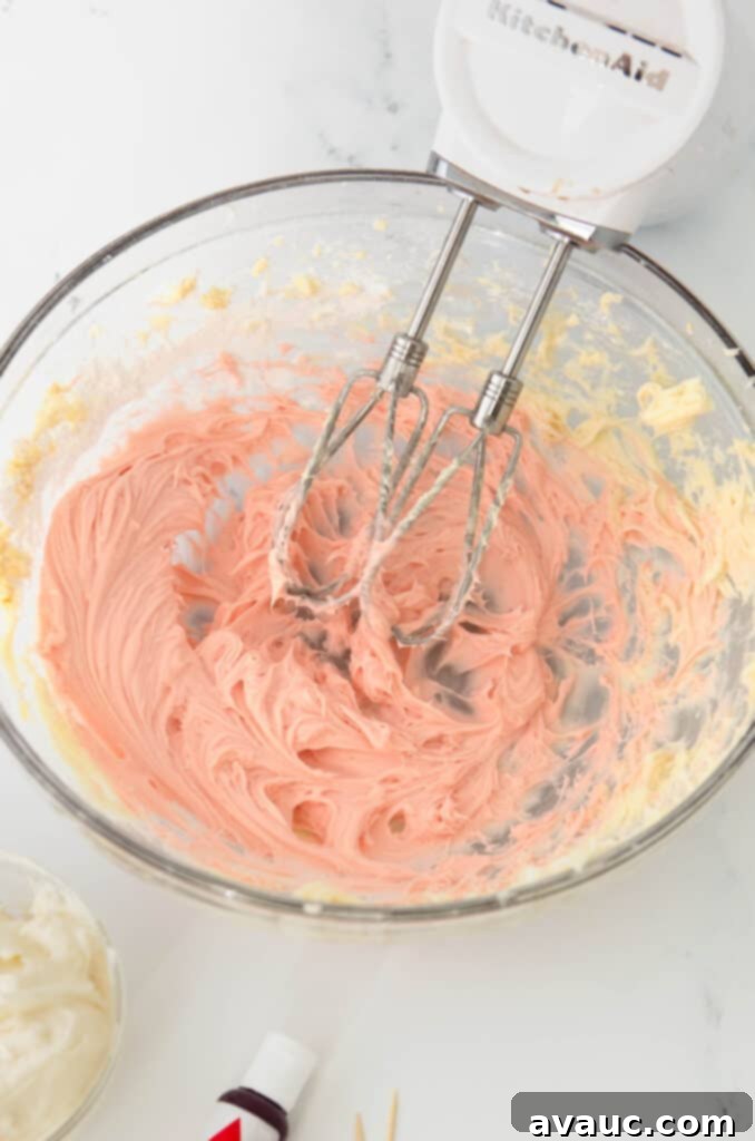 Festive Frosted Peppermint Sugar Cookies 9 Bowl of beautifully pink peppermint frosting, showcasing its smooth and creamy texture.