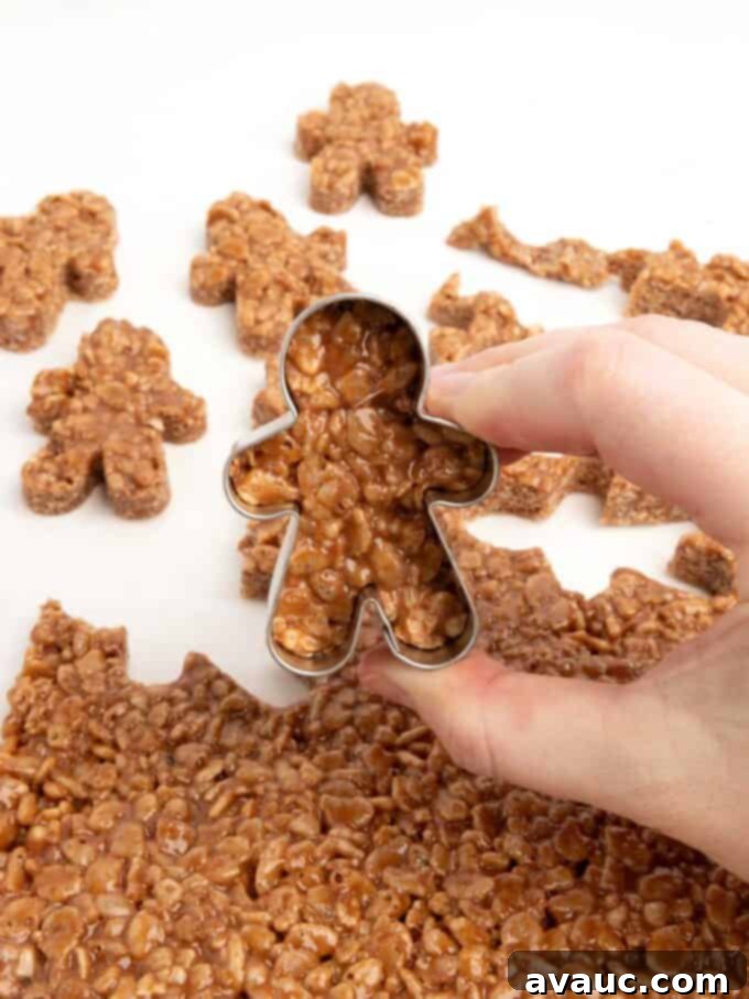 Spiced Gingerbread Krispie Treats 3 A mini gingerbread cookie cutter being used to cut out gingerbread star crunch rice krispy bars