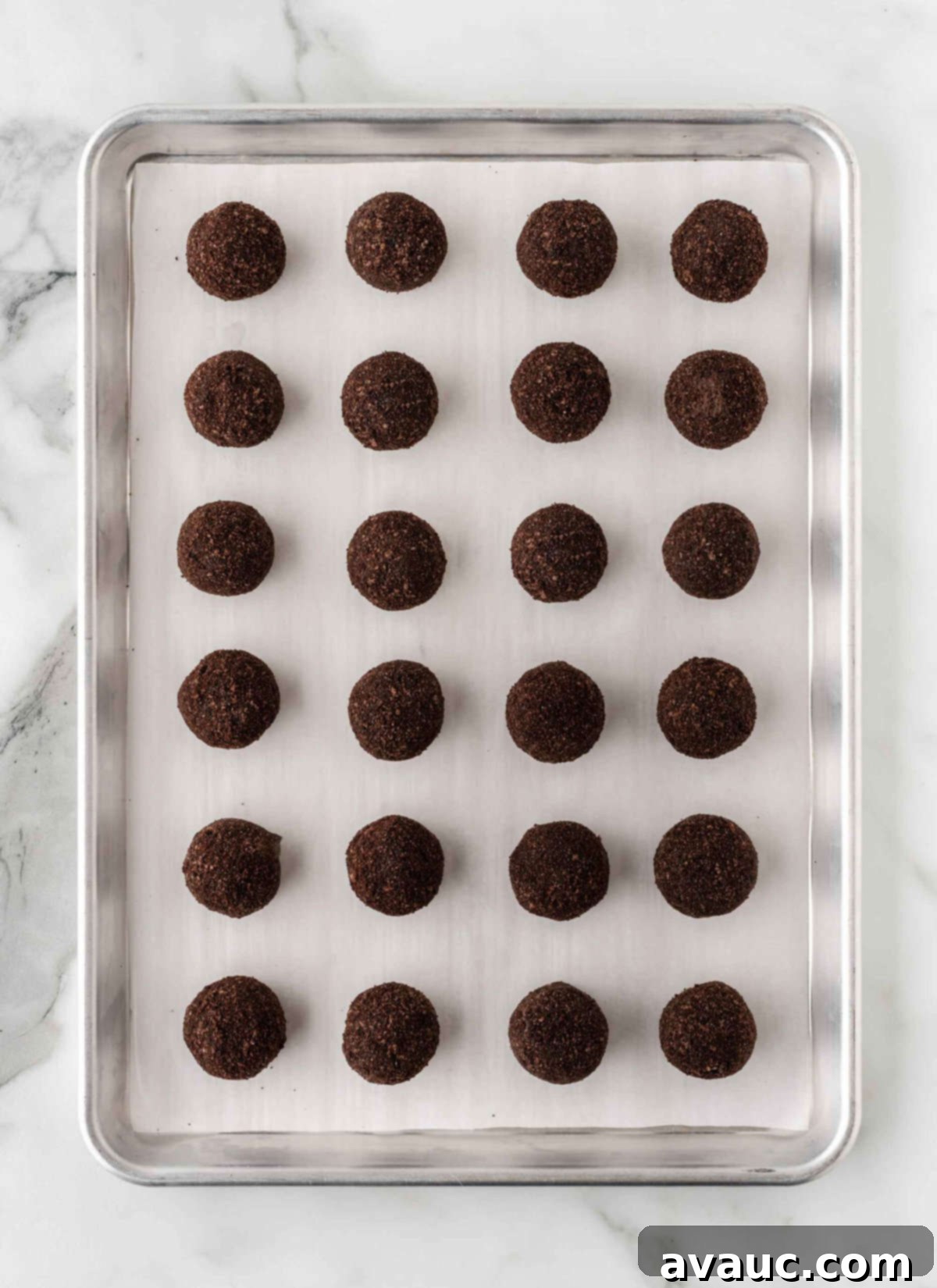 No-Dip Oreo Truffles 13 Oreo balls neatly placed on a tray in mini muffin liners after being rolled in crumbs.