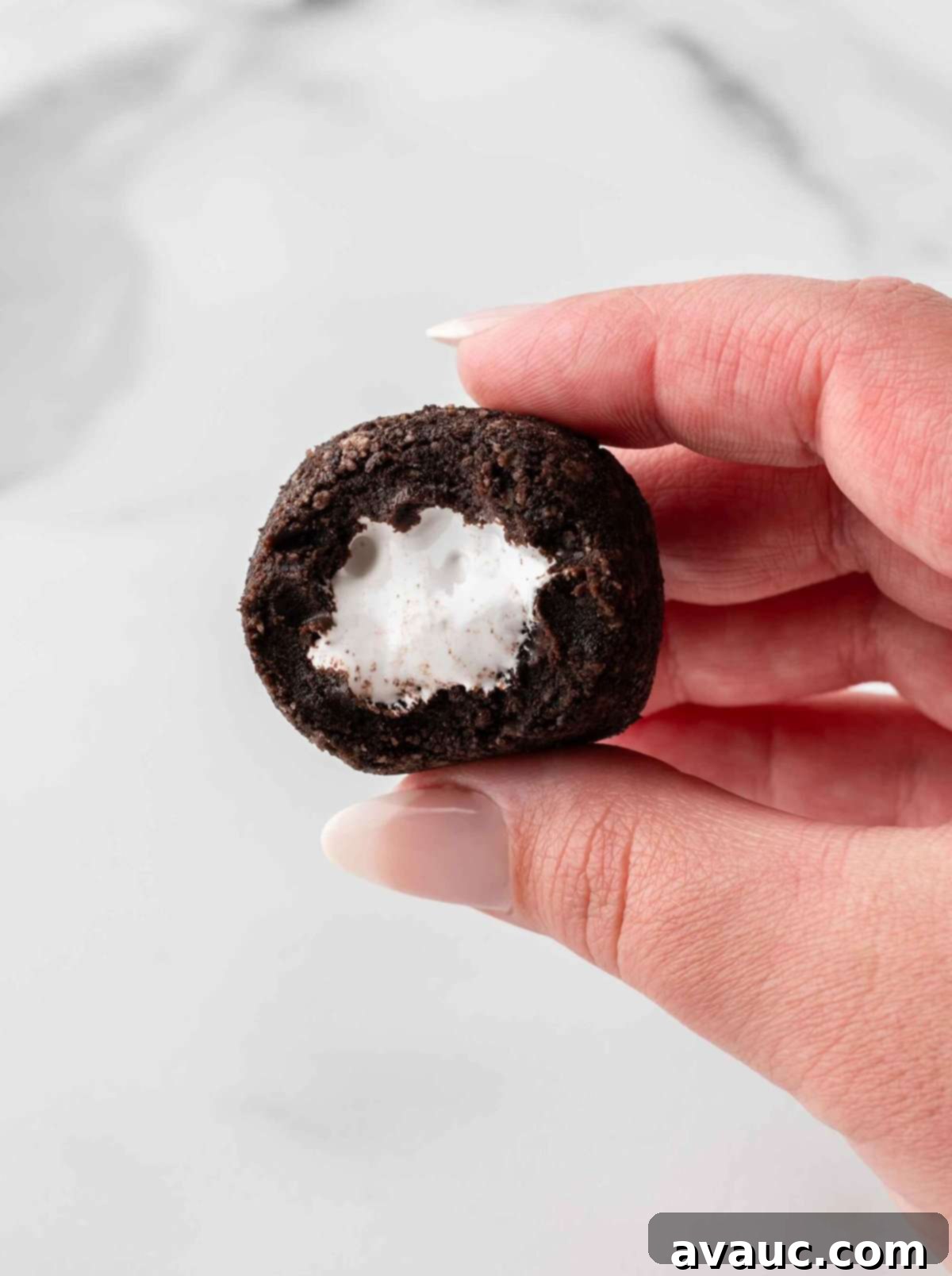 No-Dip Oreo Truffles 16 A cross-section view of an Oreo truffle, clearly showing the marshmallow fluff filling inside.