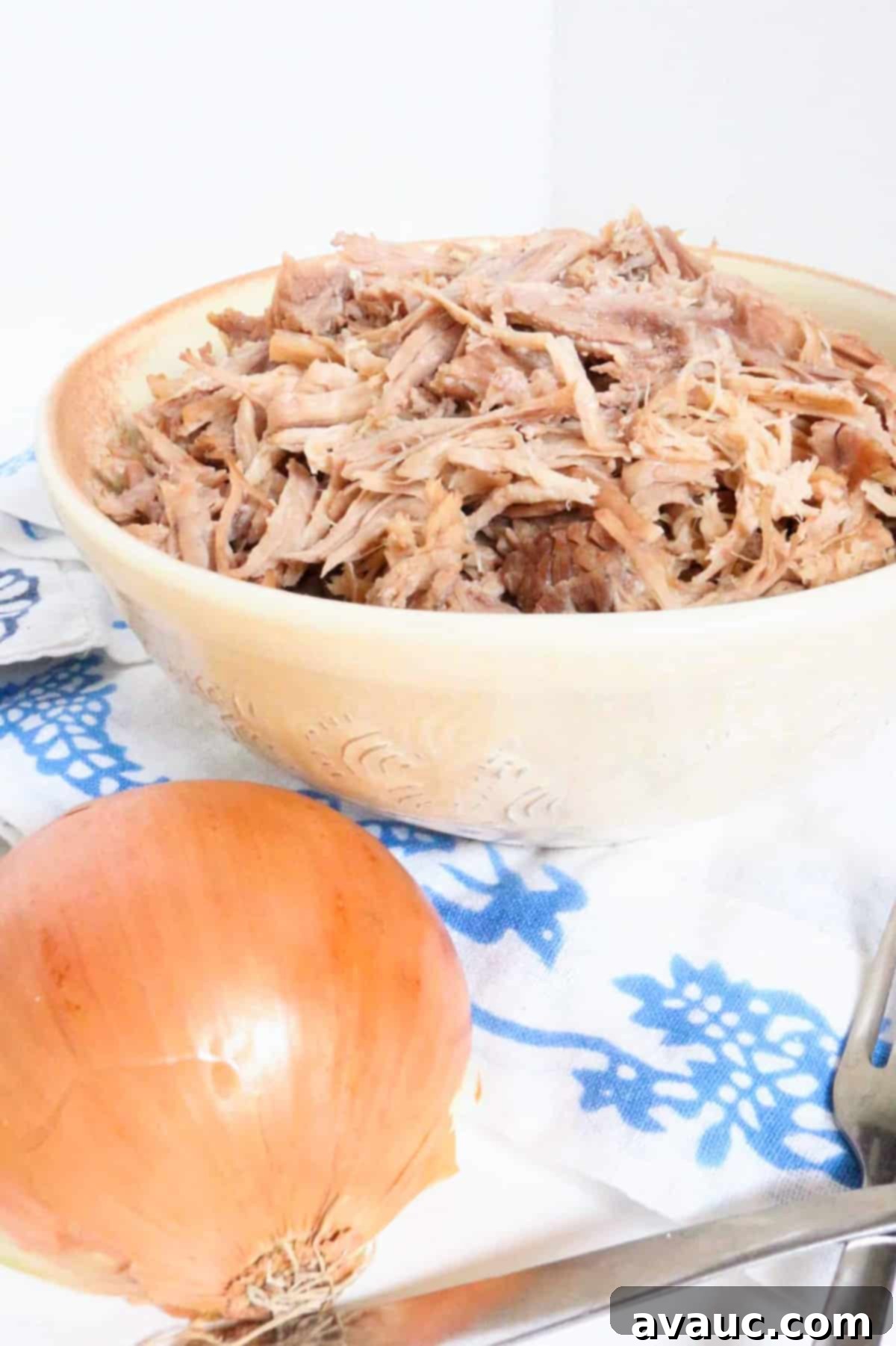 Crispy Golden Carnitas 2 Close-up of perfectly shredded Mexican pork in a bowl, ready to be served.