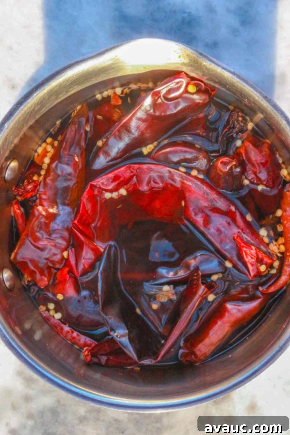 Boiling dried chiles to create a flavorful base for Chile Colorado sauce