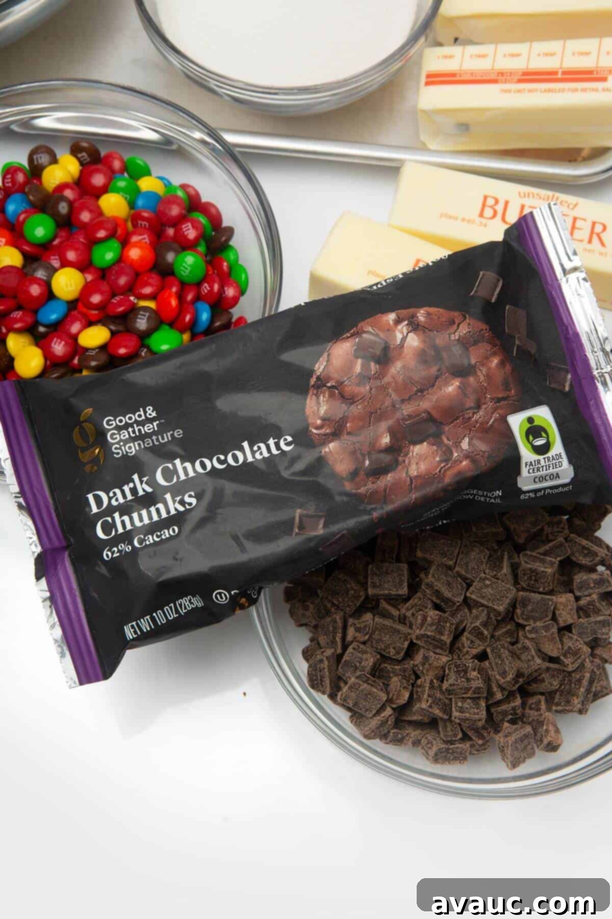 A variety of delicious mix-ins, including chocolate chips, M&Ms, and other candies, ready to be added to freezer cookie dough.