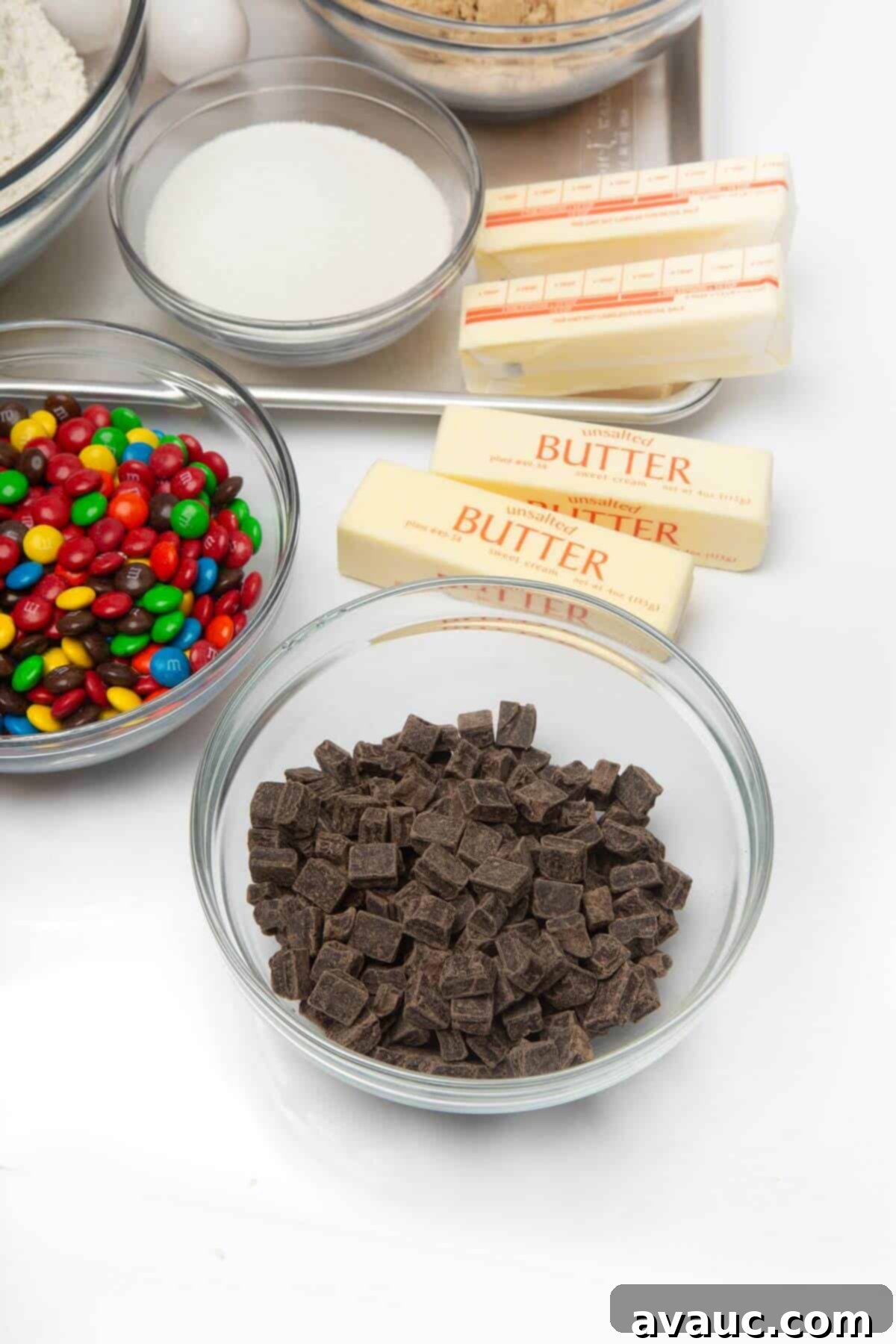 A collection of essential ingredients for making freezer cookie dough, including butter, sugars, eggs, flour, and chocolate chips.