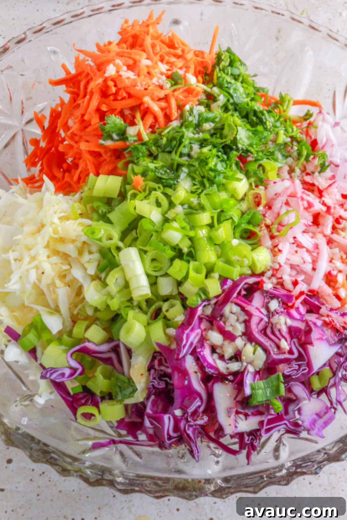 Vibrant Lime Slaw: A Mayo-Free Delight 7 Tossing coleslaw ingredients with vinaigrette in a large bowl