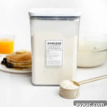 homemade pancake mix in a container with a scoop