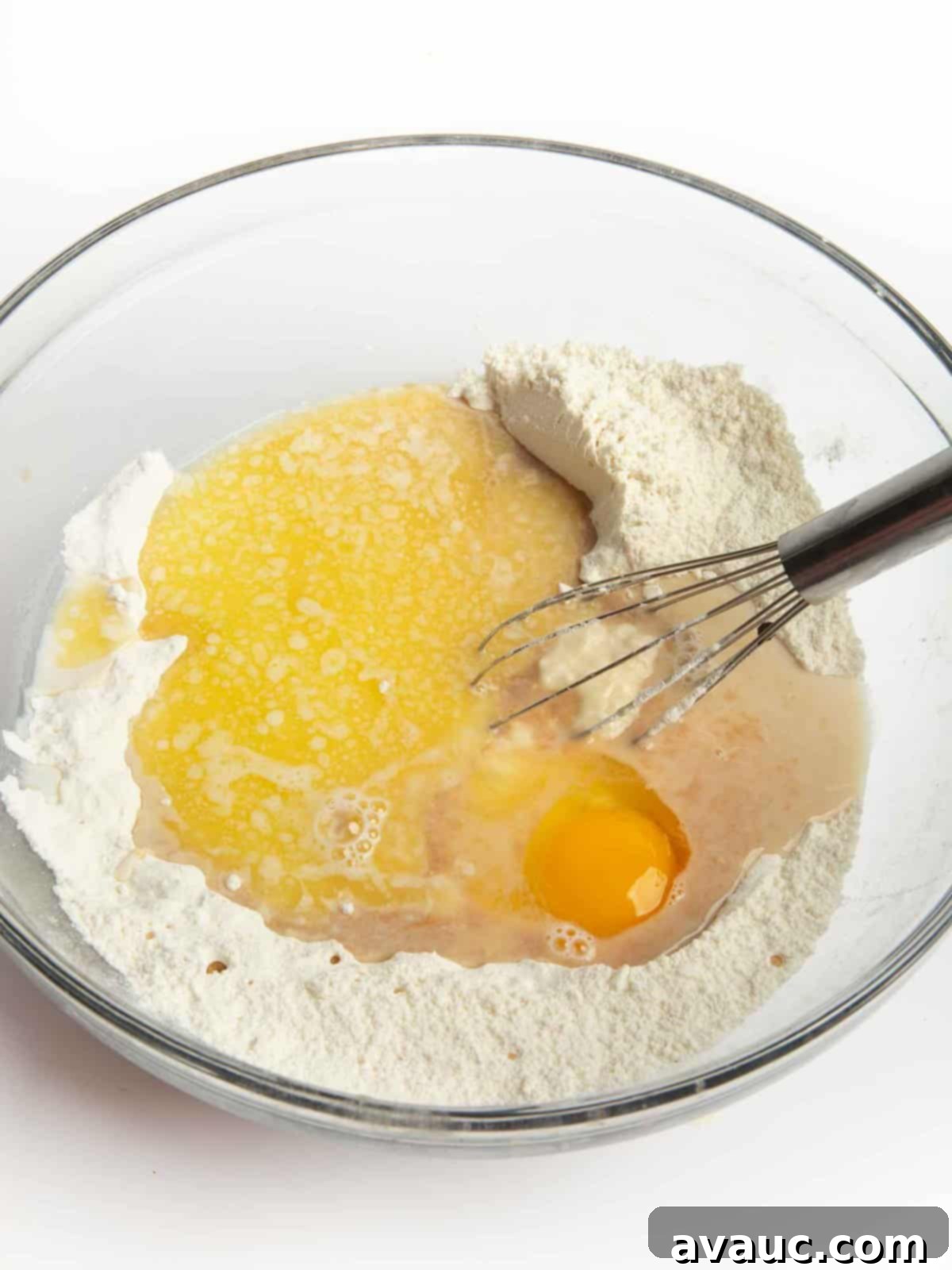 pancake batter being poured onto a griddle