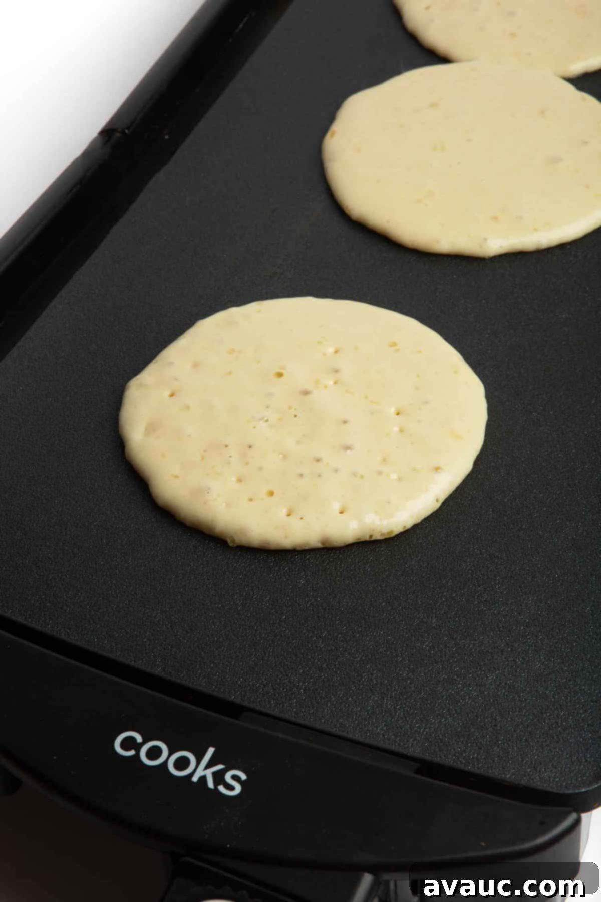 pancakes being flipped on a griddle
