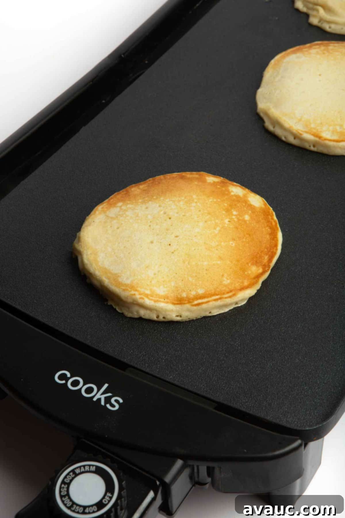 golden brown fluffy pancakes stacked on a plate