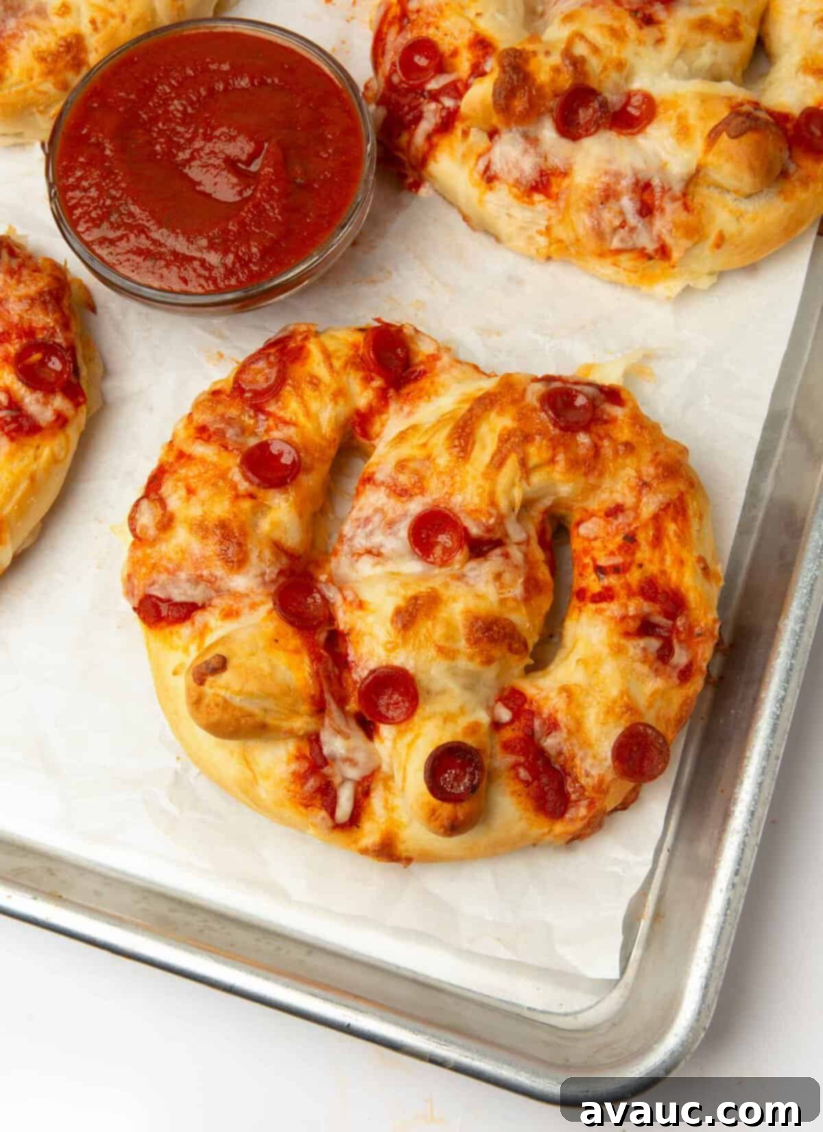 1-Hour Pizza Pretzel Twists 2 Soft and cheesy homemade pizza pretzels on a baking sheet, ready to be enjoyed.