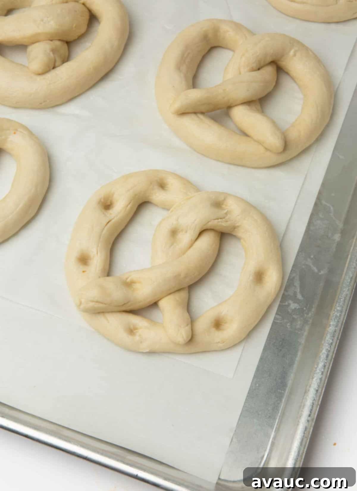 1-Hour Pizza Pretzel Twists 12 Pretzel dough shaped and placed on a baking sheet, with small indentations for toppings.