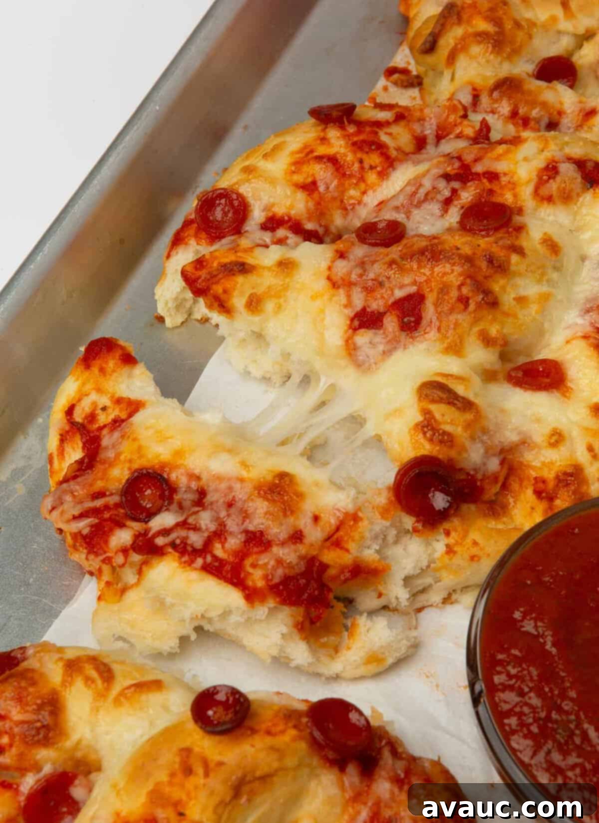 1-Hour Pizza Pretzel Twists 3 Close-up of a finished pizza pretzel, showcasing the golden-brown crust, melted cheese, and pepperoni.
