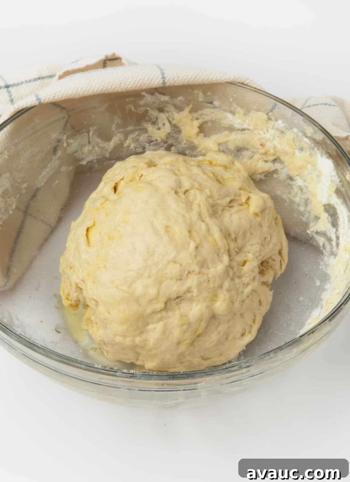 1-Hour Pizza Pretzel Twists 9 Dough ball resting in a bowl covered with plastic wrap.