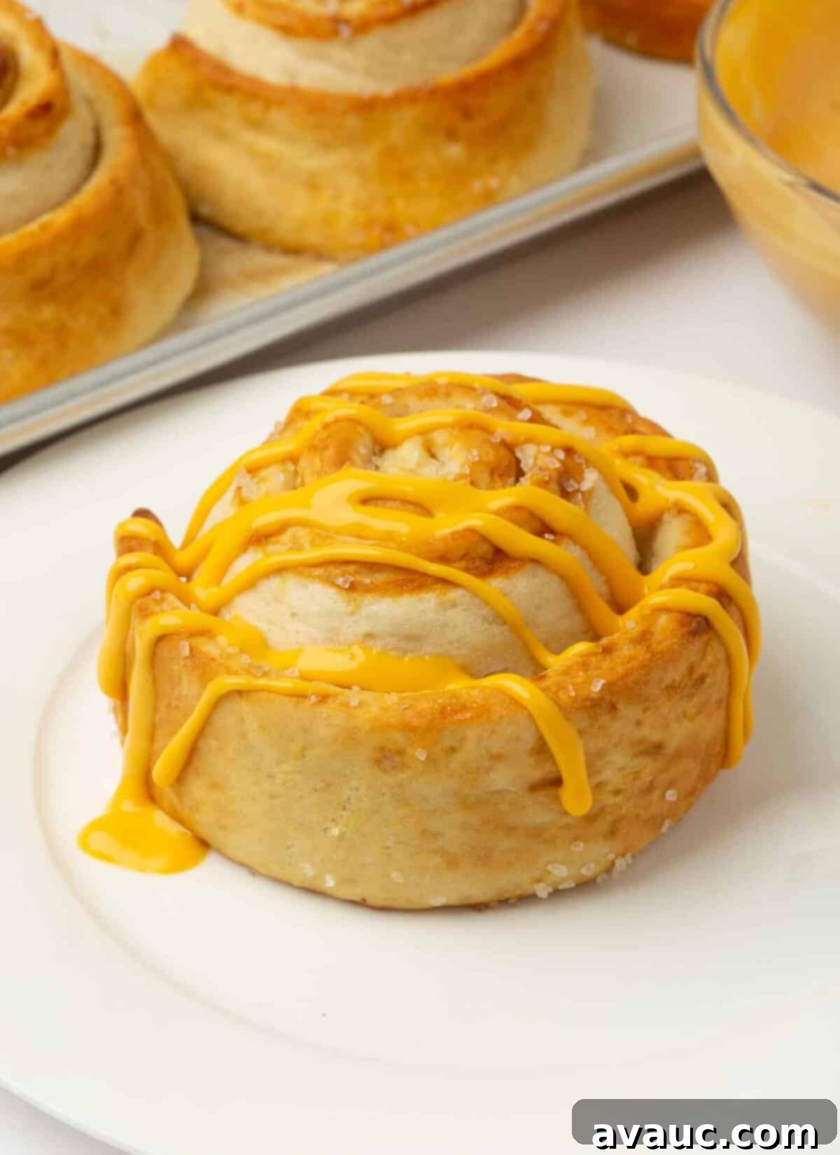 Effortless Soft Pretzel Rolls 3 Pretzel rolls drizzled with warm, melted cheese sauce.